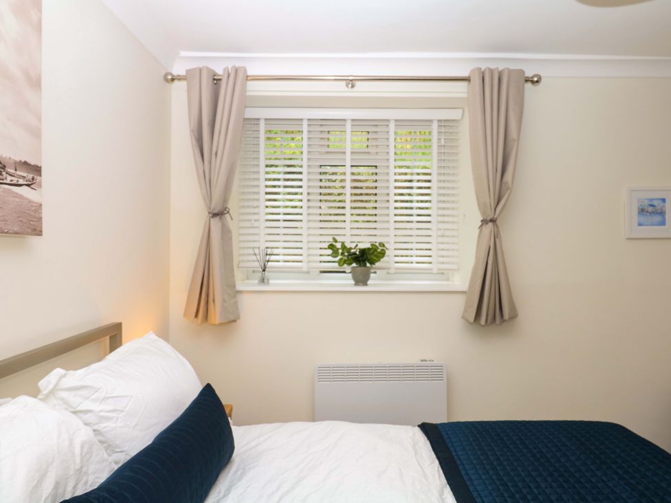 A bedroom with a bed and window at 2 Sheplegh Court Blackawton near Dartmouth