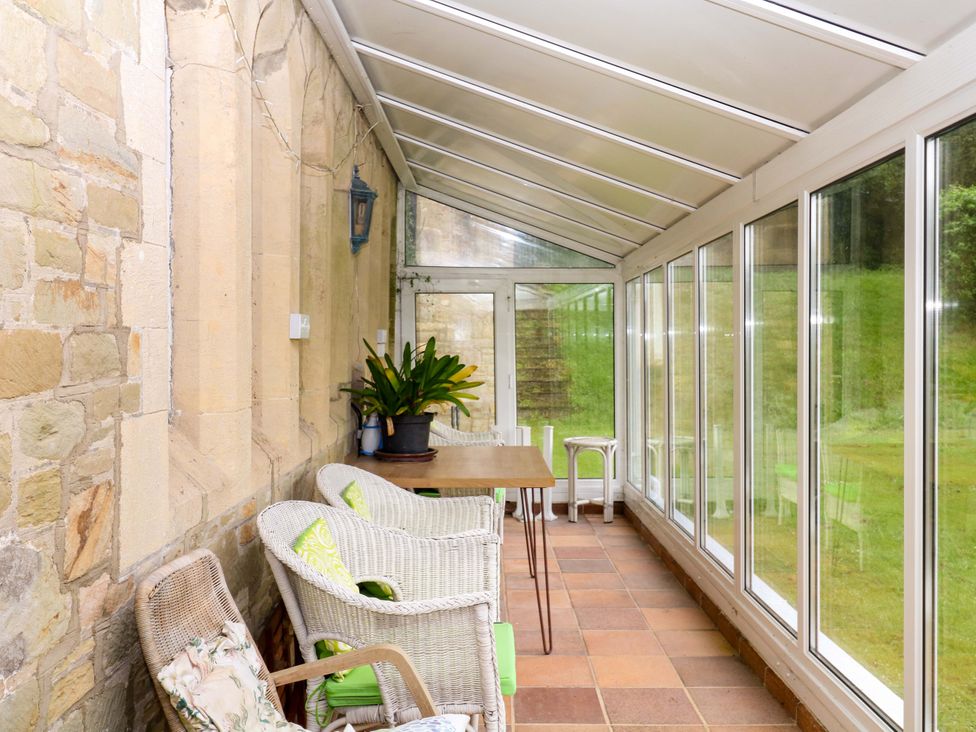 A conservatory with chairs and a table at 2 Sheplegh Court in Blackawton near Dartmouth