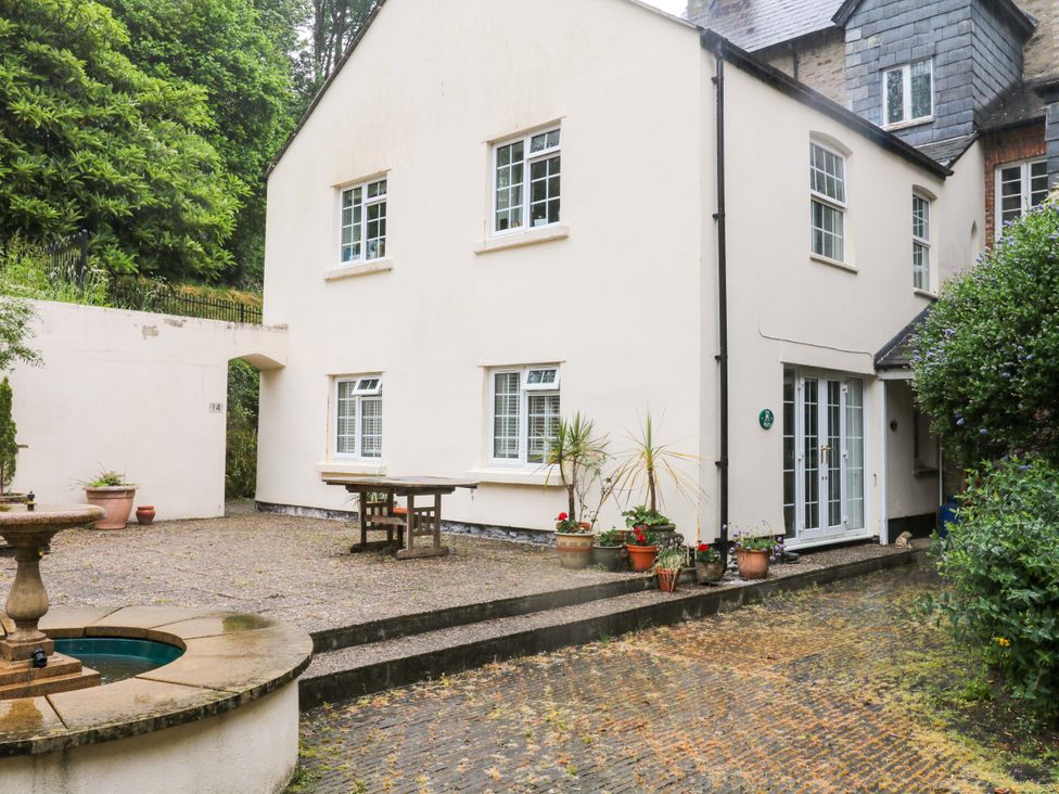 An outdoor area with a table and plants at 2 Sheplegh Court Blackawton near Dartmouth