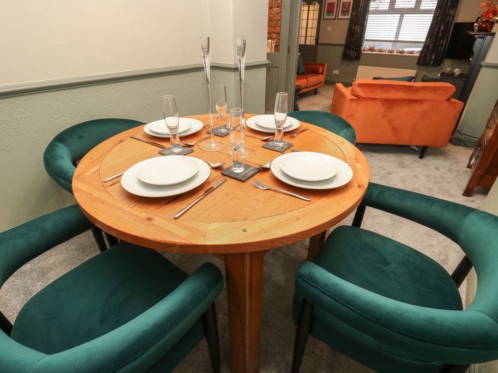 A dining room with table set for meal at Franbols Cottage in Shelf