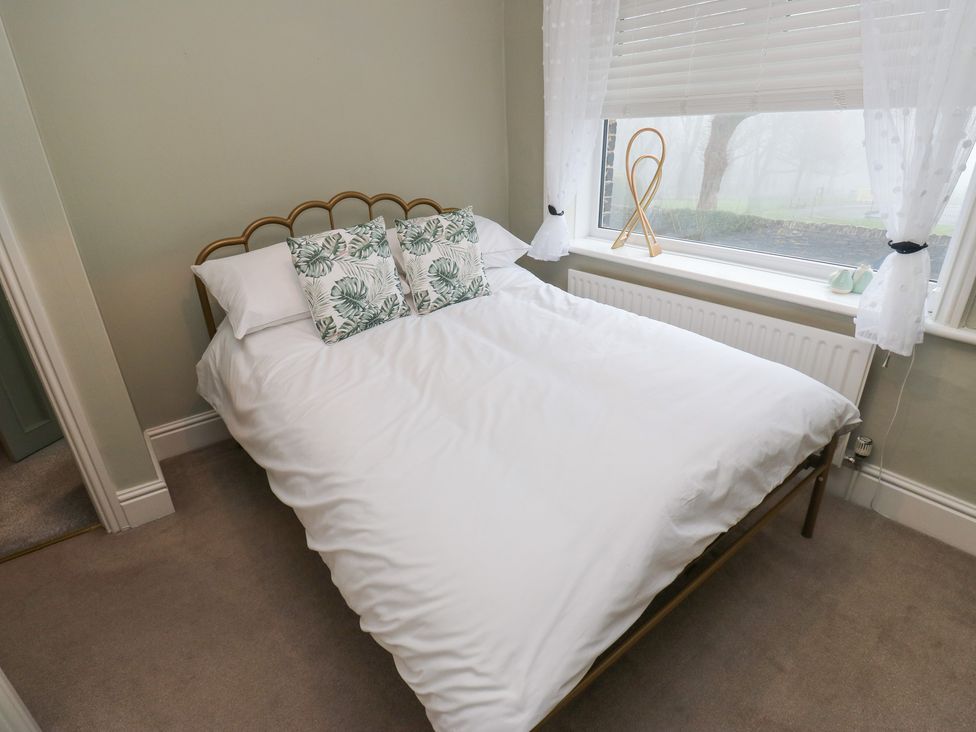 A bedroom with a bed and pillows at Franbols Cottage in Shelf