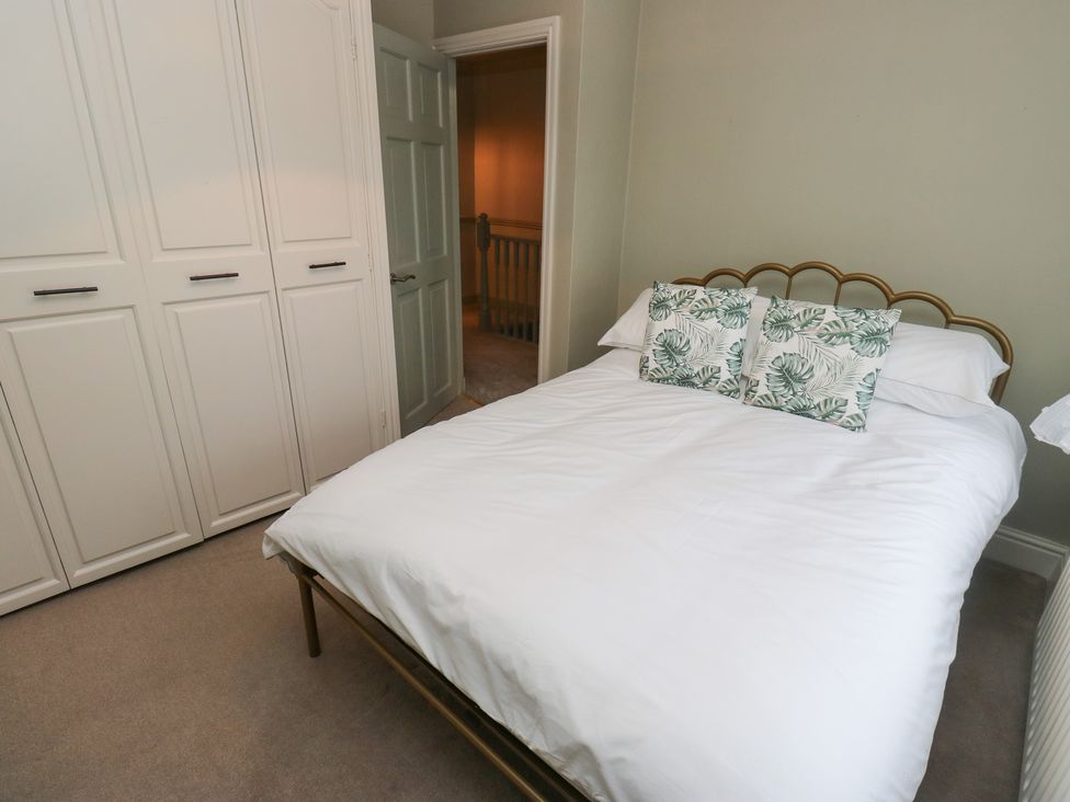 A bedroom with a bed and wardrobe at Franbols Cottage in Shelf