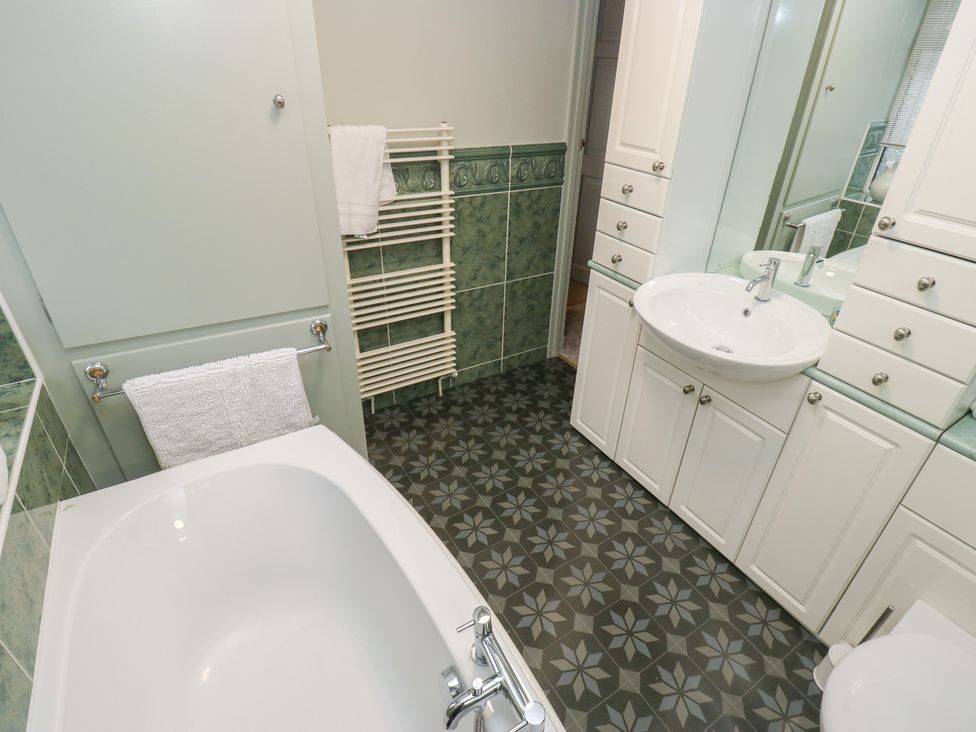 A bathroom with a bathtub and sink at Franbols Cottage in Shelf