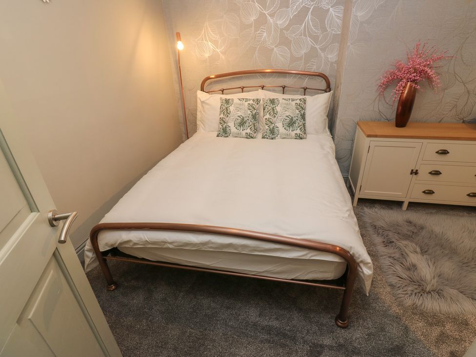 A bedroom with a bed and dresser at Franbols Cottage in Shelf