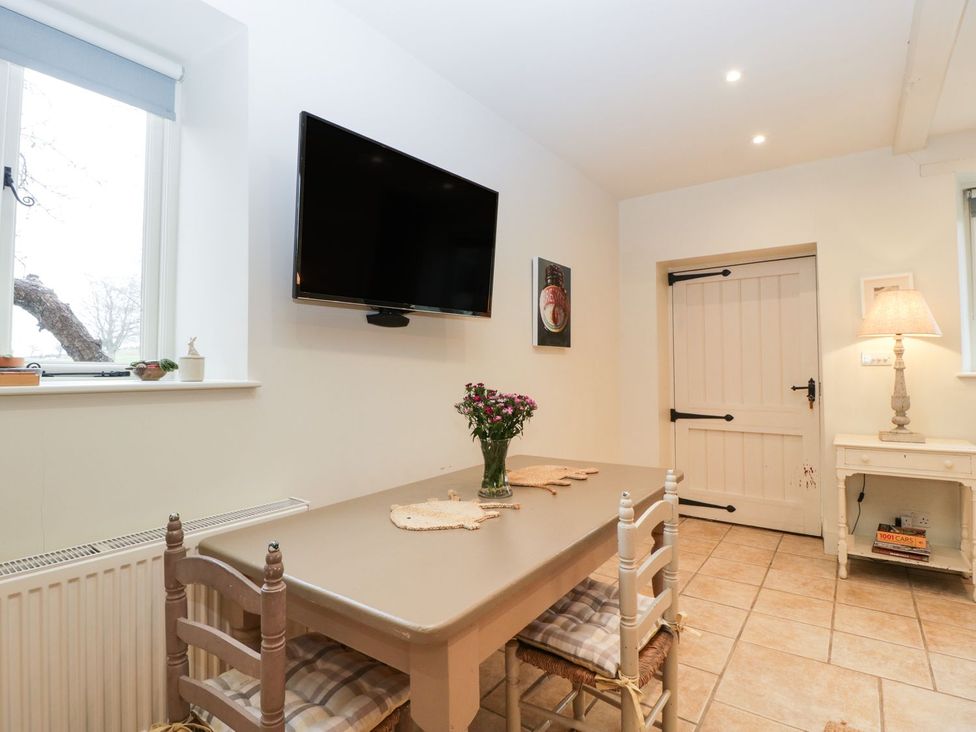 A dining room with a table and chairs at The End Langport