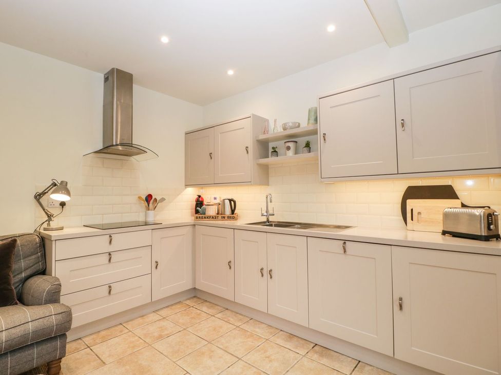 A kitchen with cabinets and appliances at The End in Langport