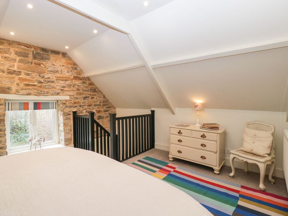 A bedroom with a bed and a window at The End in Langport
