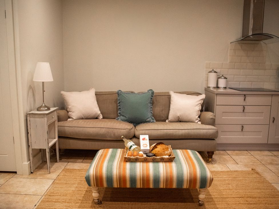 A living room with a sofa and coffee table at The End Low Ham near Langport