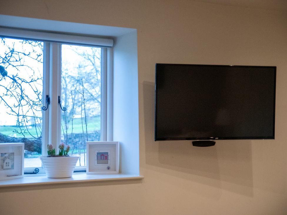 A living room with a window and television at The End Low Ham near Langport