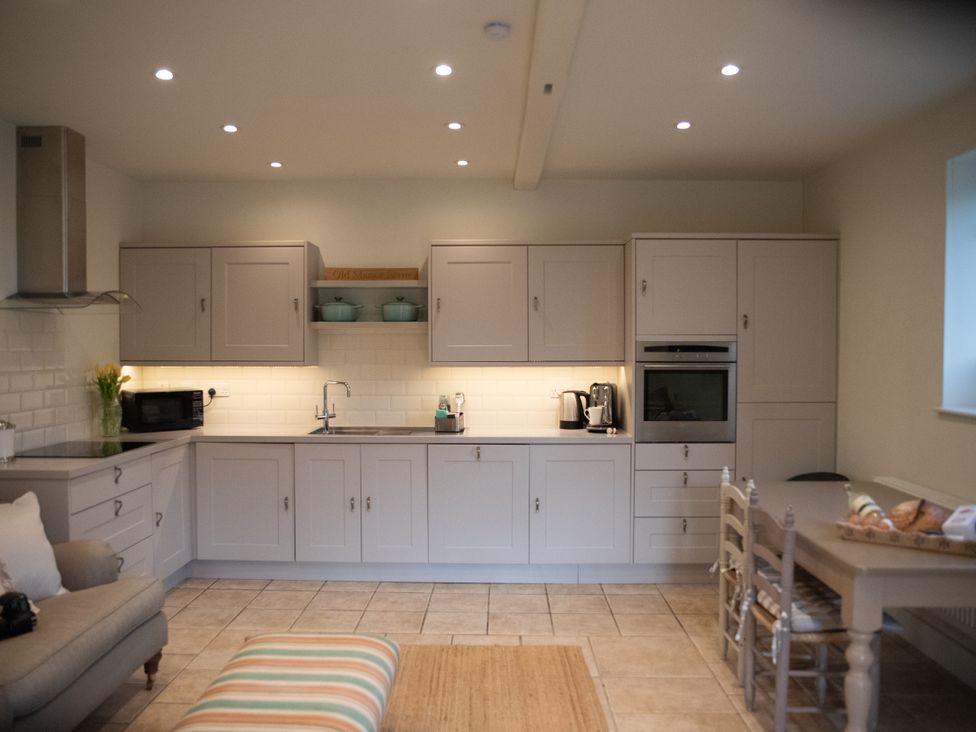 A kitchen with cabinets and appliances at The End in Low Ham near Langport