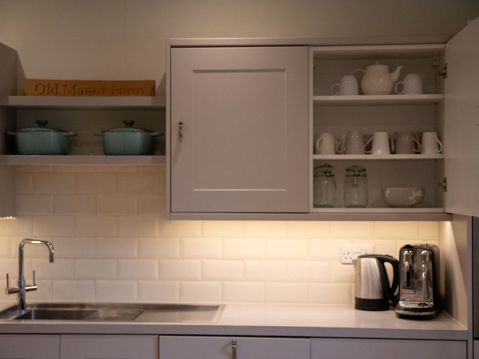 A kitchen with plumbing fixtures and storage at Old Manor Farm in Low Ham near Langport