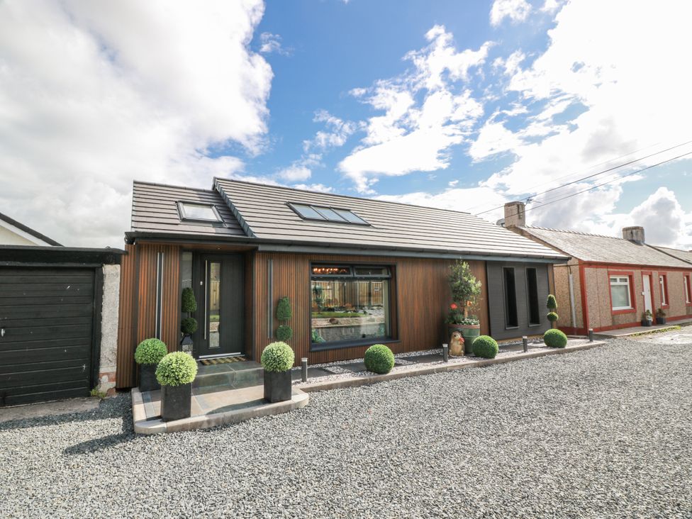 A house with a garden and gravel driveway at Scotia At The Brig Annan