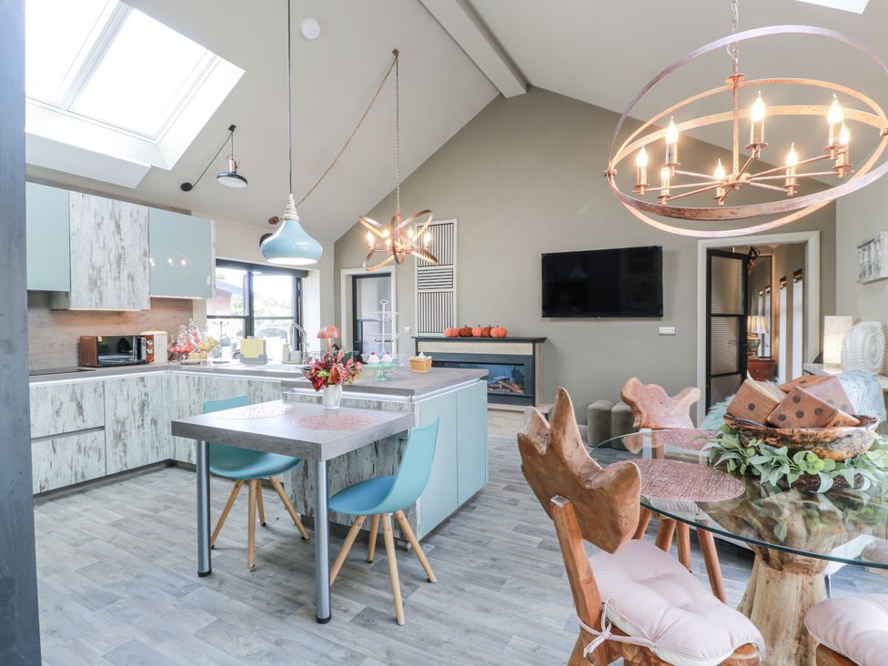 A kitchen with modern furniture and appliances at Scotia At The Brig Annan