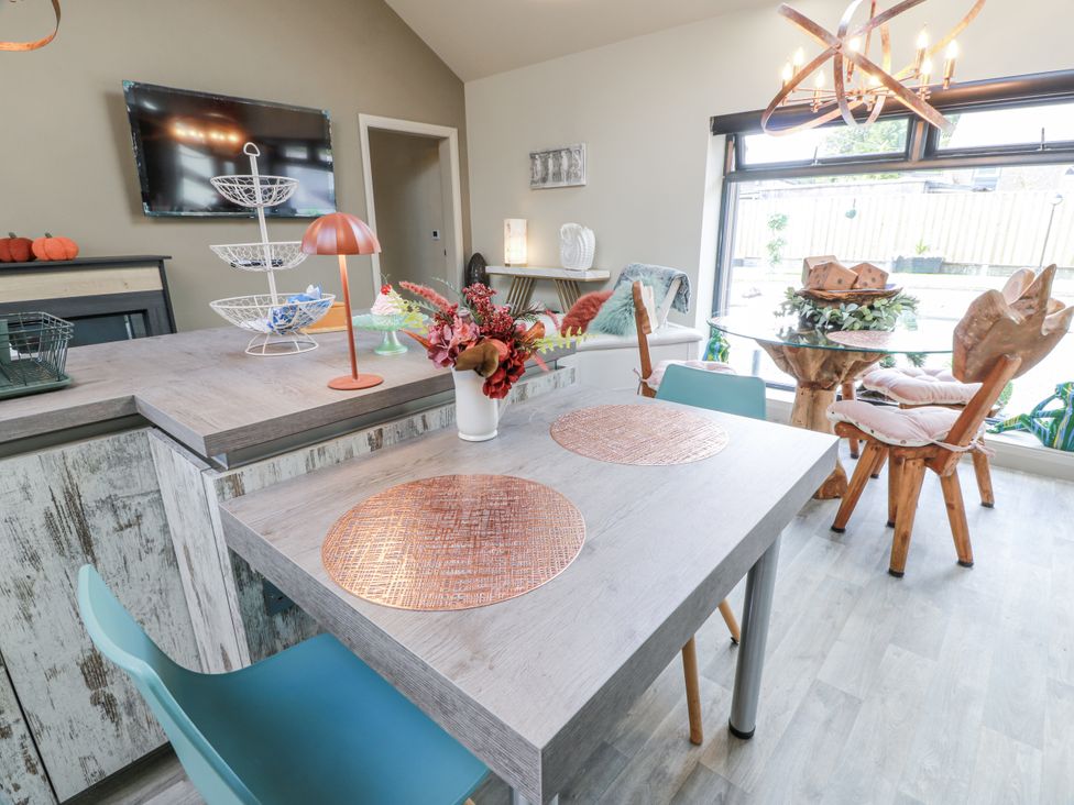 A dining room with a table and chairs at Scotia At The Brig Annan