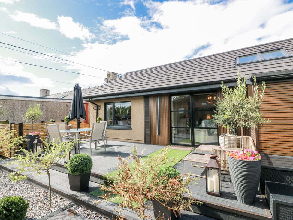 An outdoor area with table and chairs at Scotia At The Brig Annan