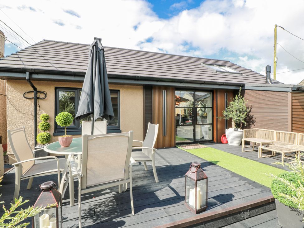 An outdoor area with seating and plants at Scotia At The Brig Annan