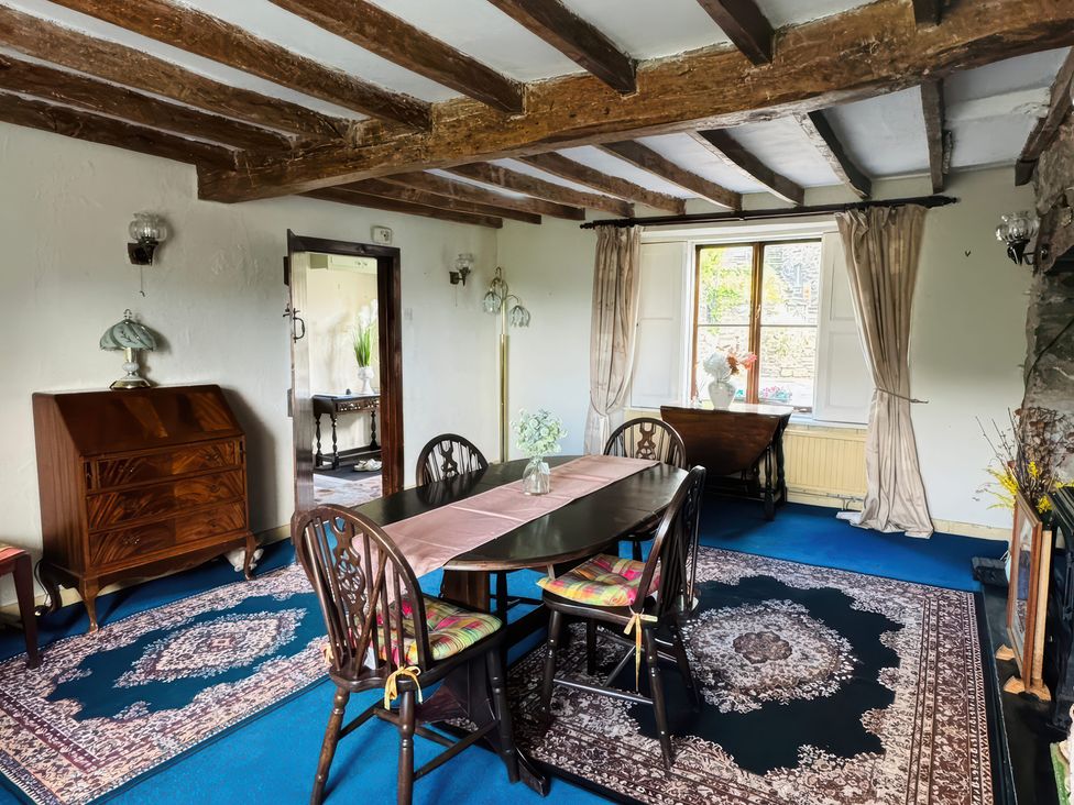 A dining room with a table and chairs at The Old Post Office in null