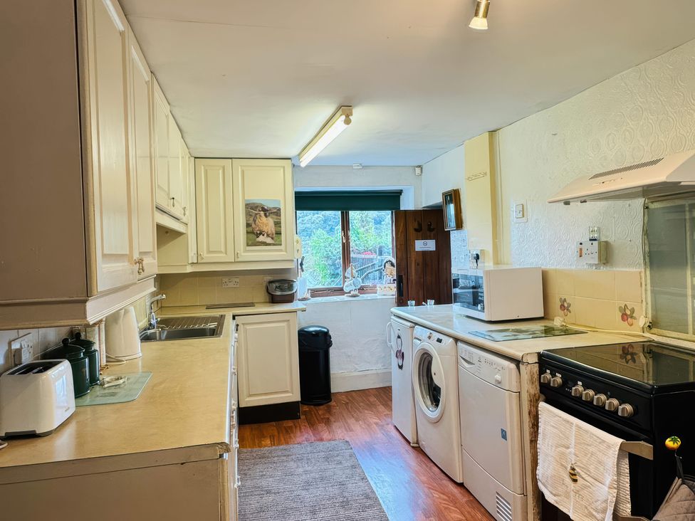 A kitchen with appliances and windows at the Old Post Office in null