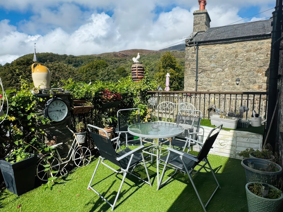 An outdoor patio with a table and chairs at The Old Post Office in null