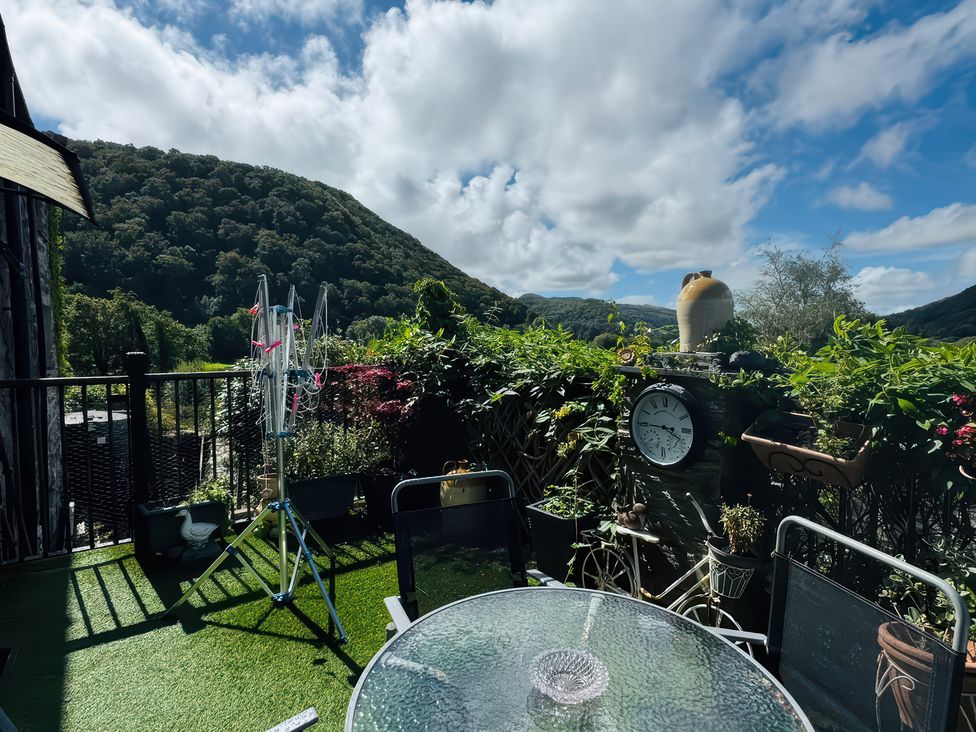 An outdoor area with table and chairs and a clock at The Old Post Office in null
