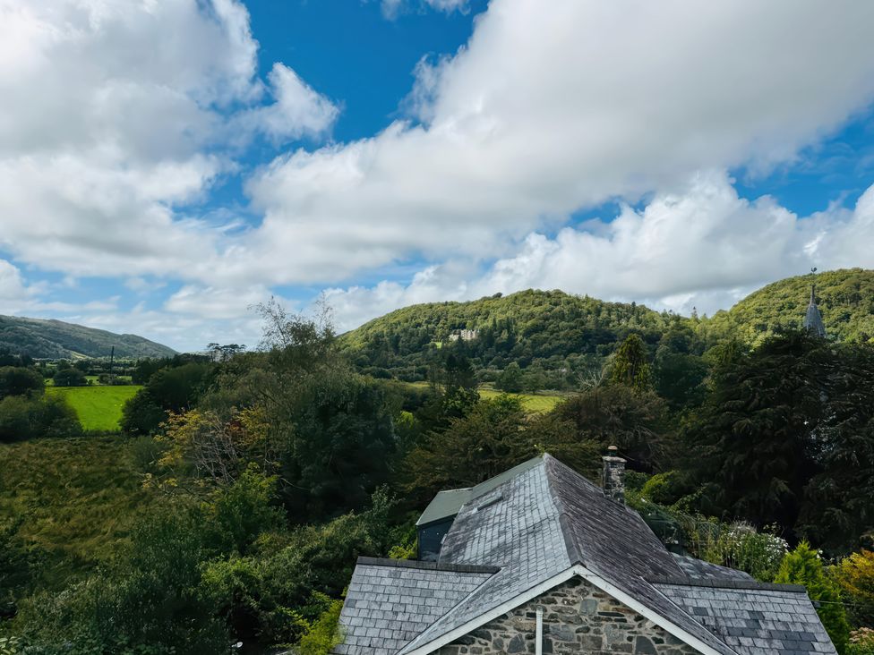 A view of mountains and greenery under a cloudy sky at The Old Post Office null
