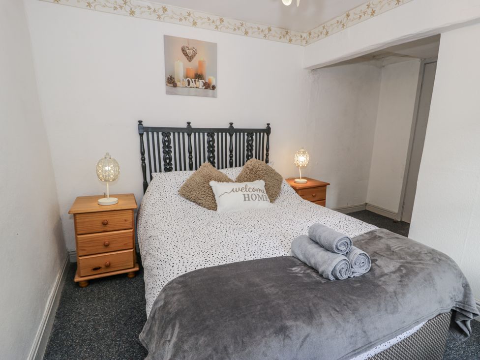 A bedroom with a bed and nightstands at The Old Post Office in null