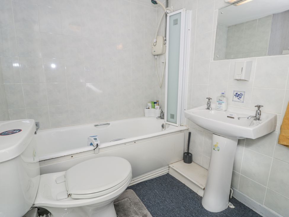 A bathroom featuring a bathtub, toilet, sink, and shower at The Old Post Office in null