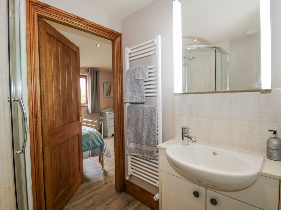 A bathroom with a sink and towels at Bluebell Cottage
