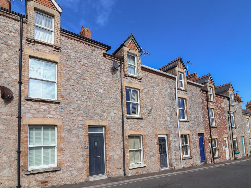 Row of houses with stone facades on a street at Lenny's Place in Watchet