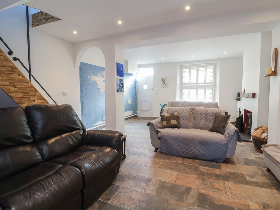 A living room with sofas and a staircase at Lenny's Place in Watchet