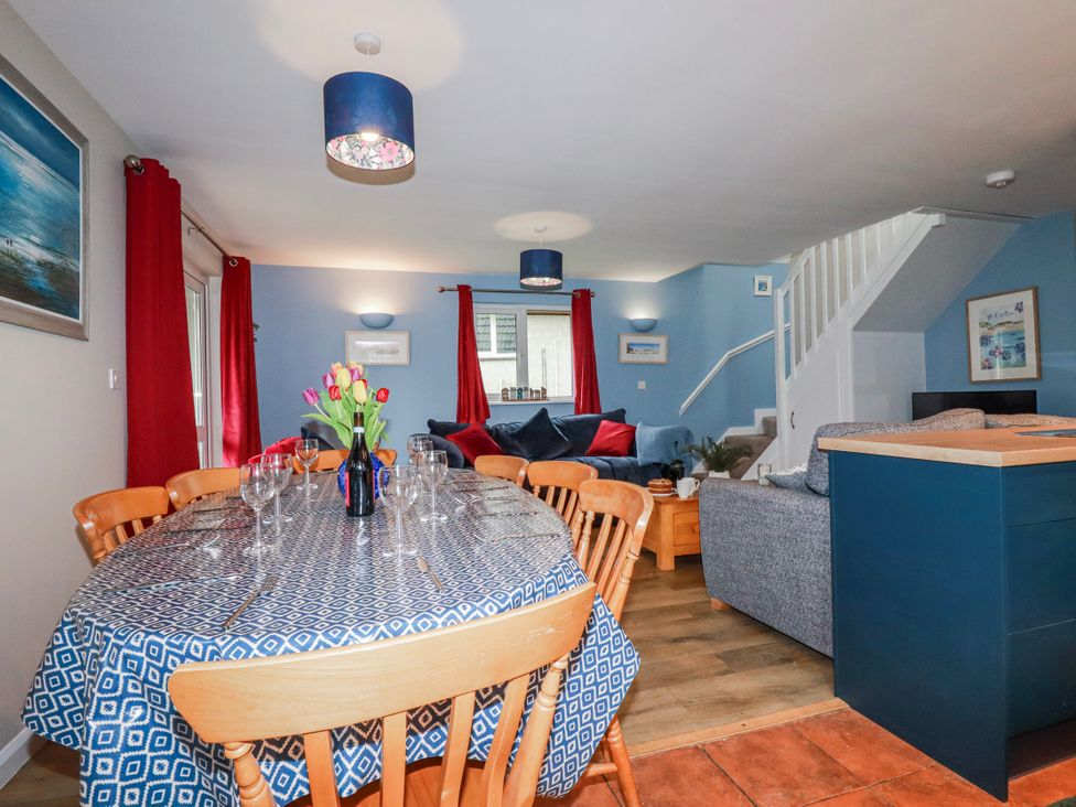 A dining area with a table and chairs at Mayfly Lodge St Tudy