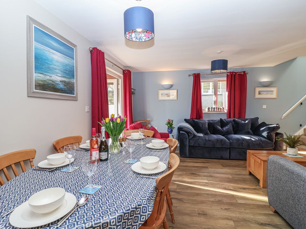 A dining room with table and chairs at Mayfly Lodge in St Tudy