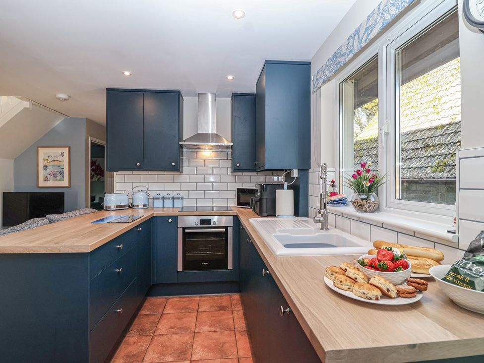 A kitchen with cabinets and a countertop at Mayfly Lodge in St Tudy
