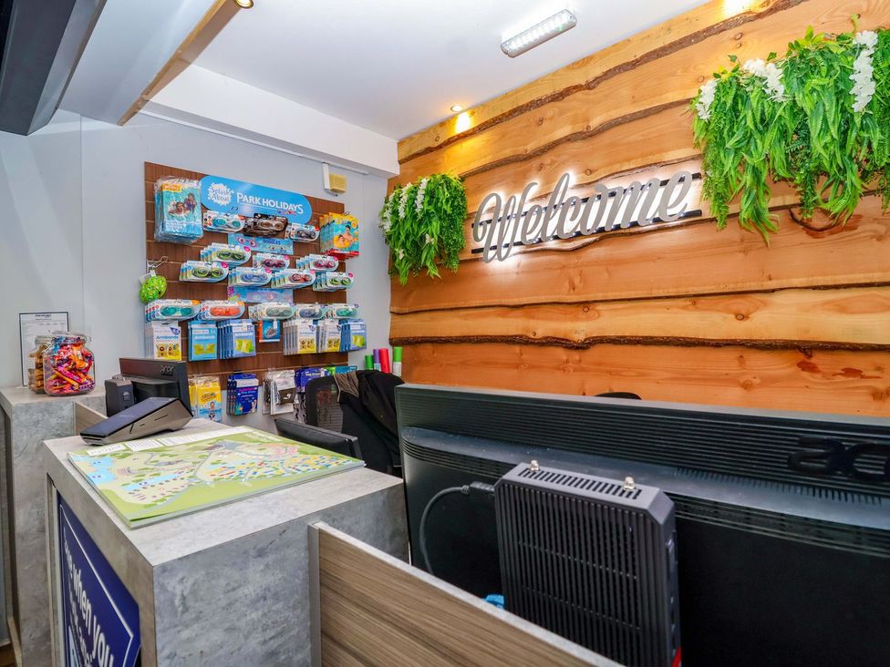 A reception area with a desk and brochures at Mayfly Lodge in St Tudy