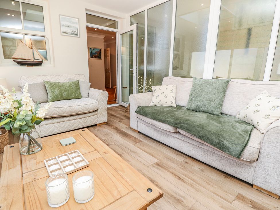 A living room with sofas and a coffee table at 6 Priory in Shanklin