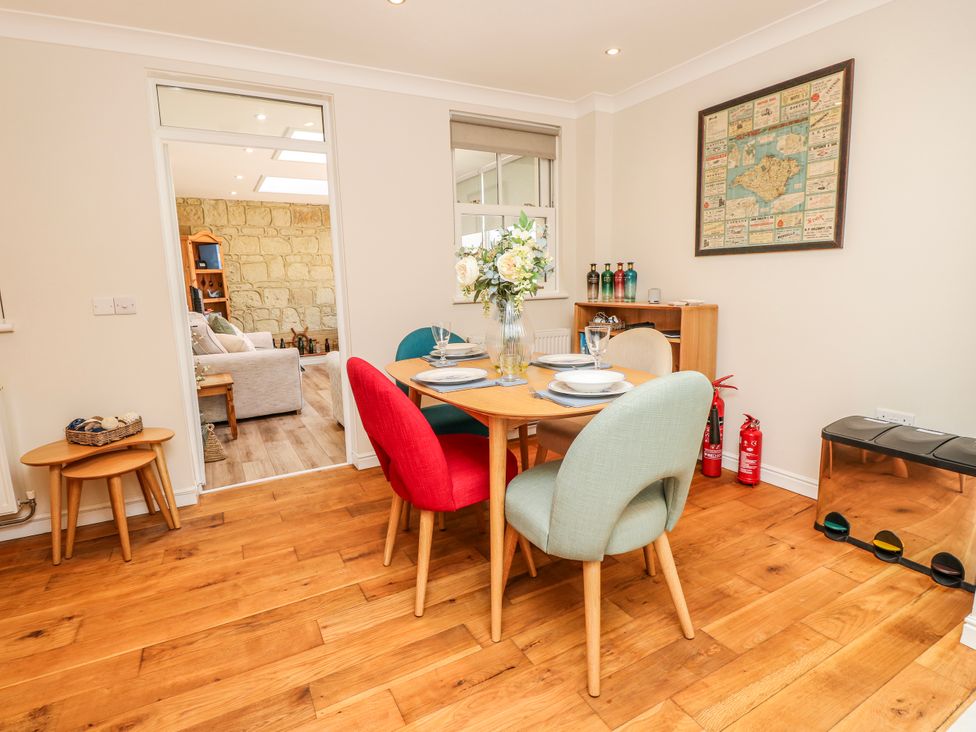 A dining room with a table and chairs at 6 Priory in Shanklin