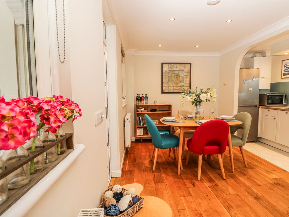 A dining room with a table and chairs at 6 Priory in Shanklin