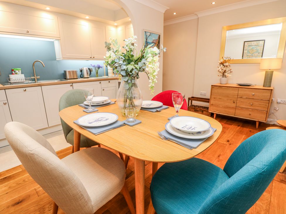 A dining room with a table set for meals at 6 Priory Shanklin