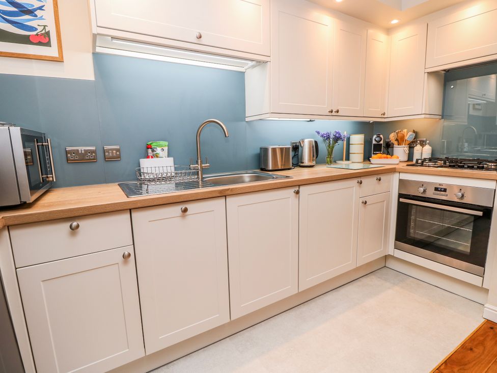 A kitchen with cabinets and appliances at 6 Priory Shanklin
