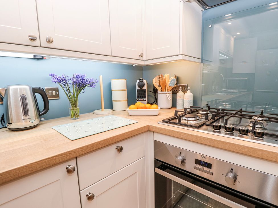 A kitchen with appliances and utensils at 6 Priory in Shanklin