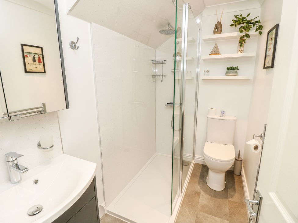 A bathroom with a shower and sink at 6 Priory in Shanklin