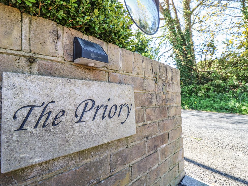 A nameplate on a wall at The Priory in Shanklin
