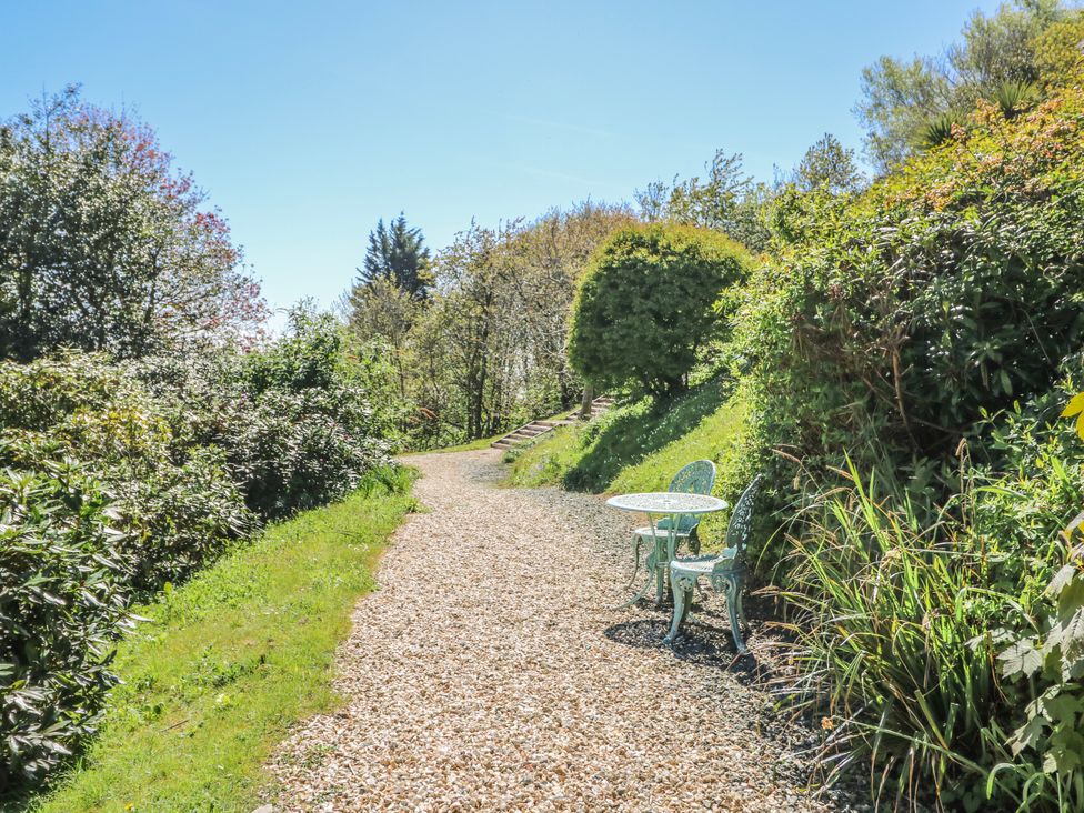 A garden path with a table and chairs at 6 Priory in Shanklin