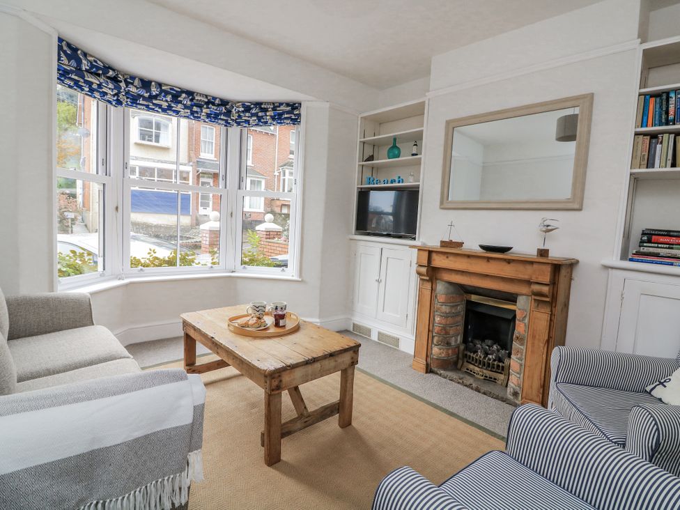 A living room with a coffee table and fireplace at Shipwrights in Salcombe