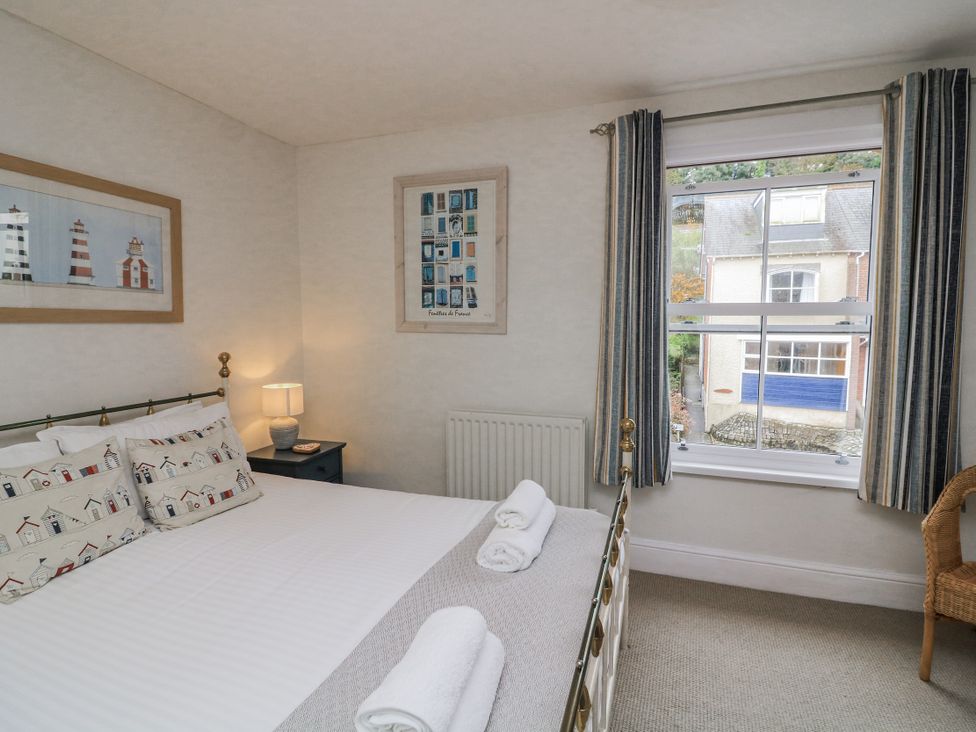 A bedroom with a bed and window at Shipwrights in Salcombe