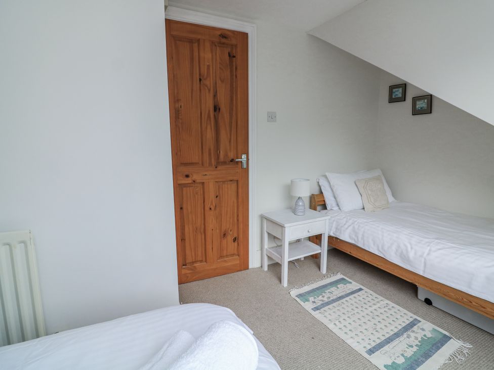 A bedroom with a single bed and nightstand at Shipwrights in Salcombe