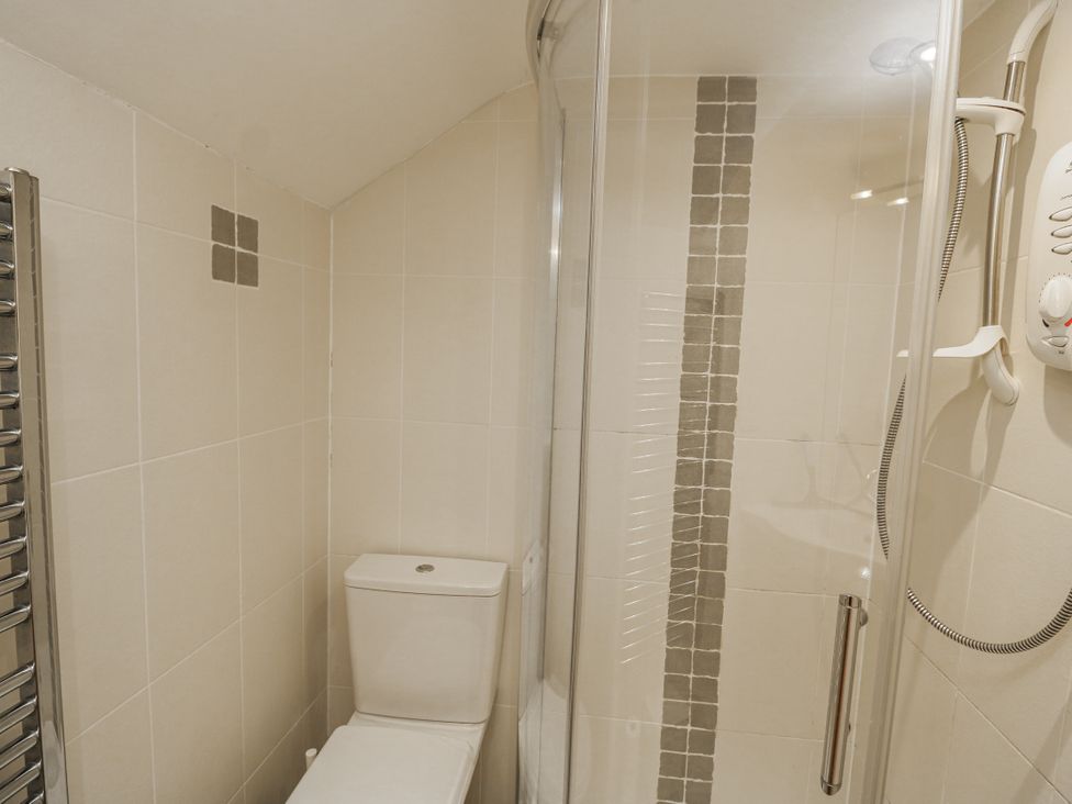 A bathroom with a shower and toilet at Shipwrights in Salcombe
