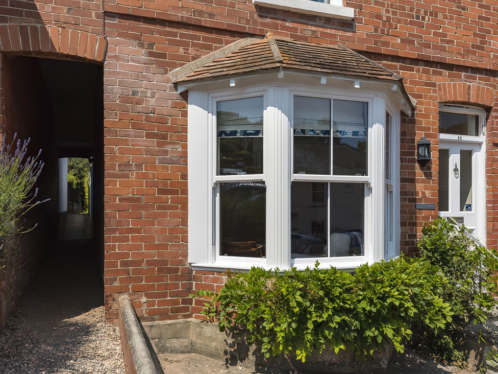 A brick exterior with windows and a door at Shipwrights in Salcombe