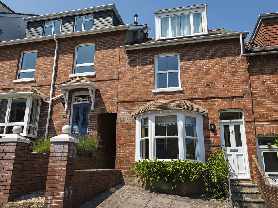 A brick house with windows and a front door at Shipwrights in Salcombe