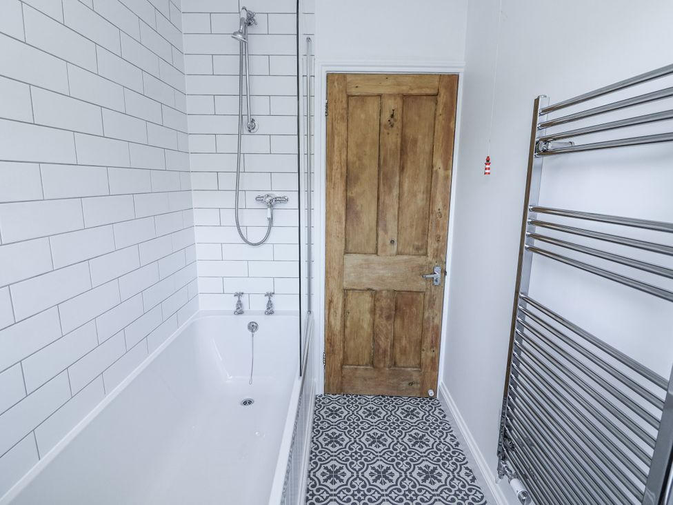 A bathroom with a bathtub and shower at Shipwrights 11 Coronation Road in Salcombe